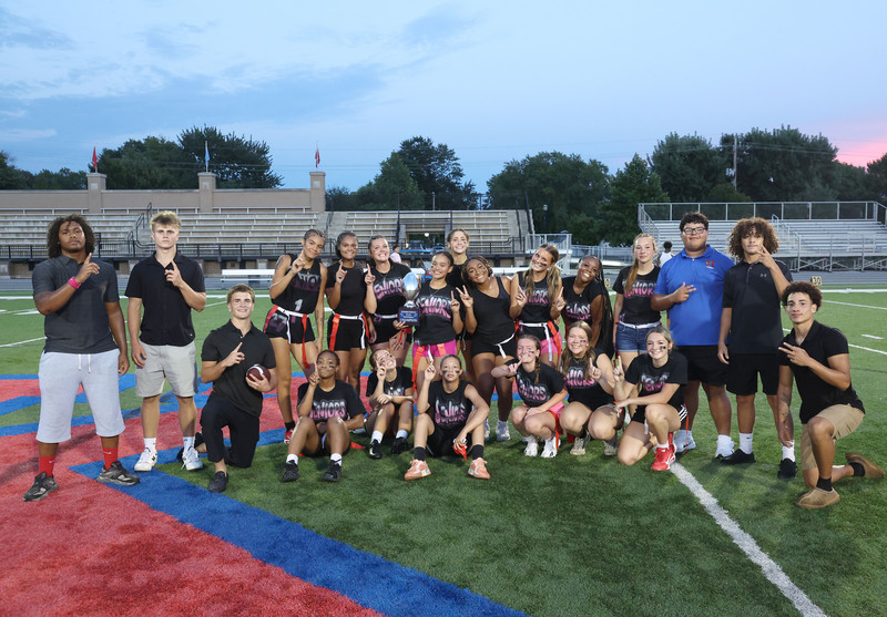 flag football team trophy group photo on field