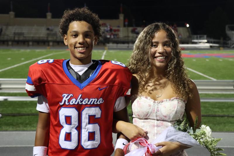 football player smiling together with girl smiling crowned king and queen