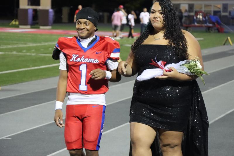 football player smiling together with girl smiling crowned king and queen