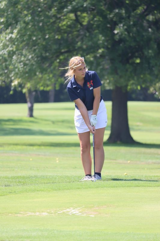 Junior Mia Drake warms up before a home golf match.