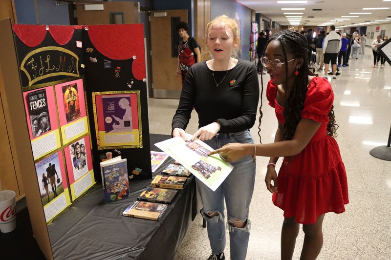 Josie Tygart and Maddi Hodson look at a display.
