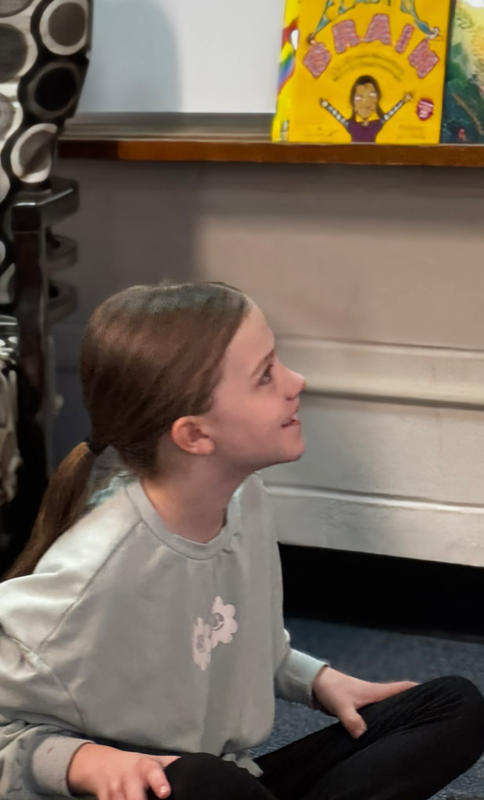 girl sitting on floor smiling