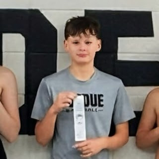 boy swimmer holding ribbon