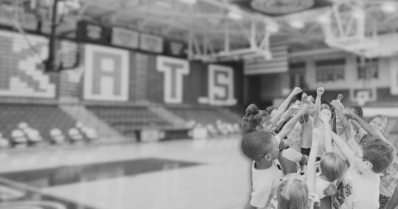 kids in huddle in basketball gym