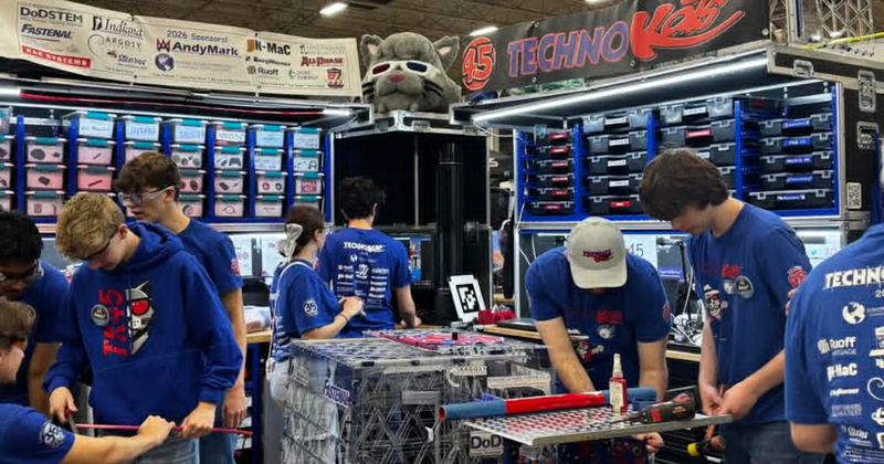 students working on robotics in Pits