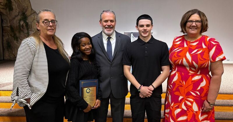 students receiving certificates from city officials