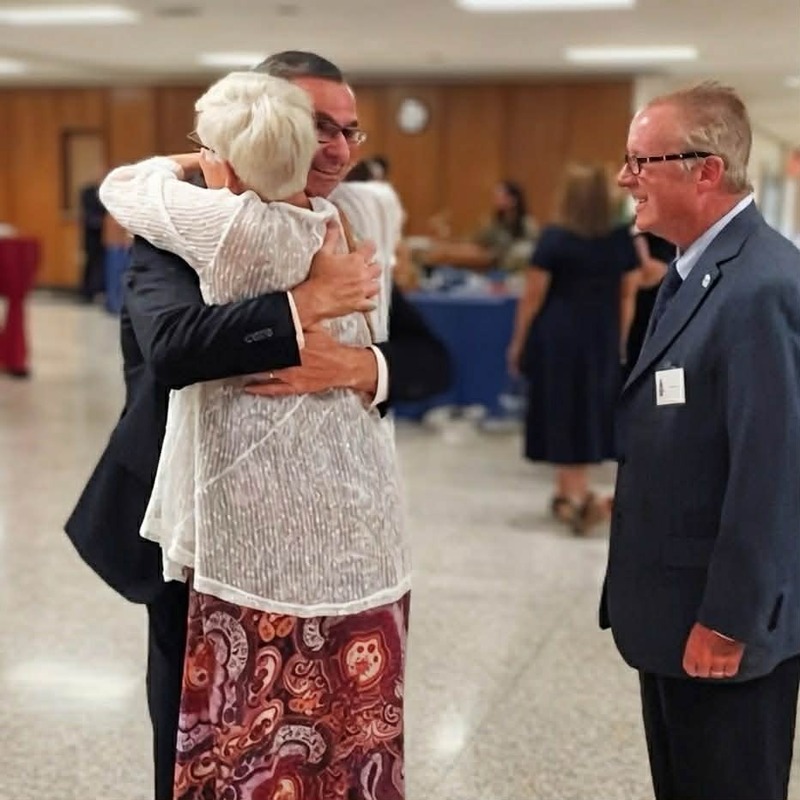 man and woman hugging