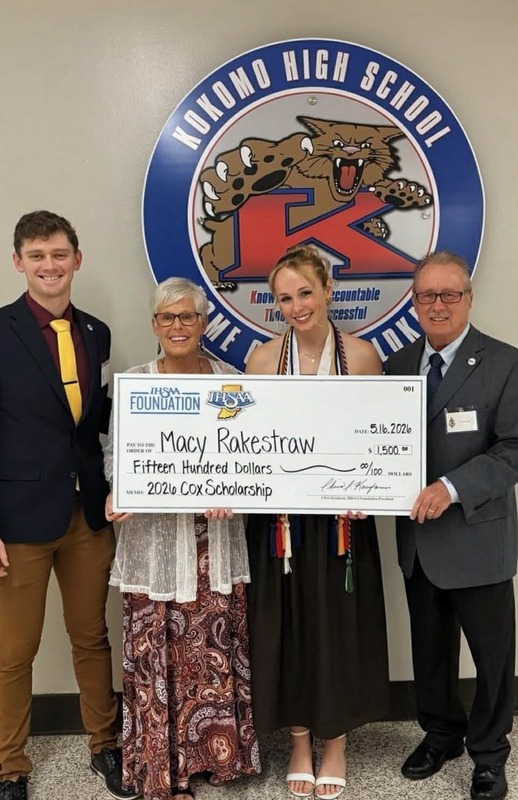 two men standing with woman and high school senior girl holding scholarship check