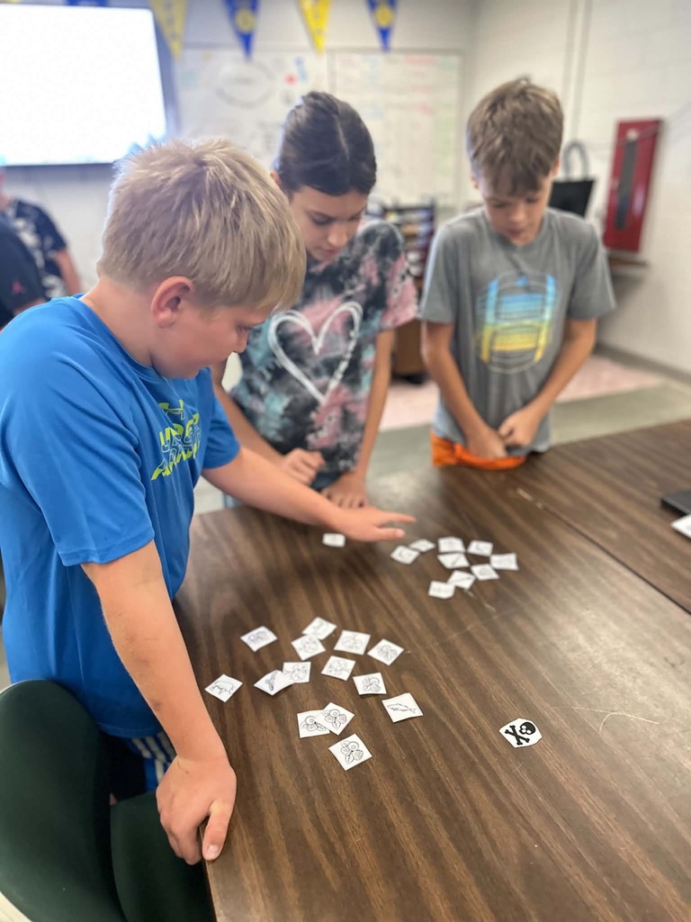 students play game with cards on a table 
