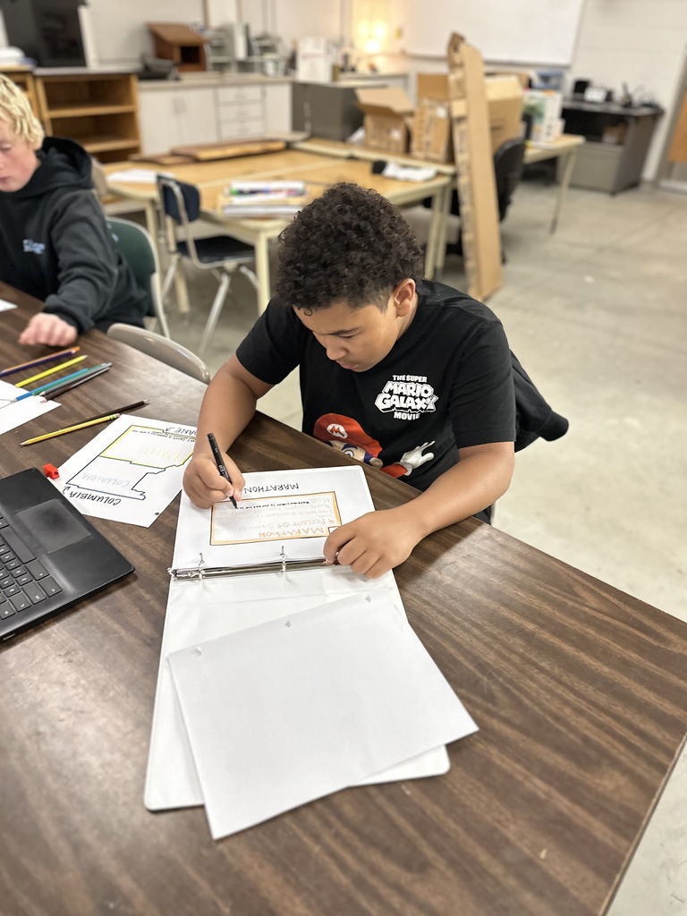 student filling out information in a binder