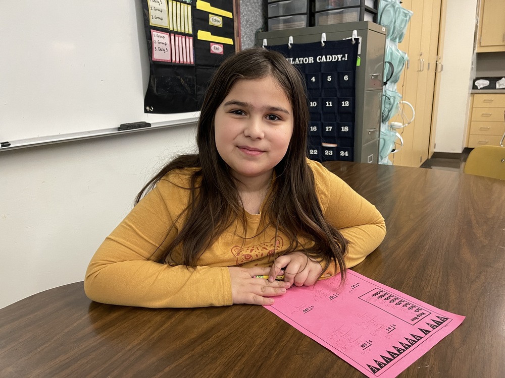 central fourth grader sitting at table