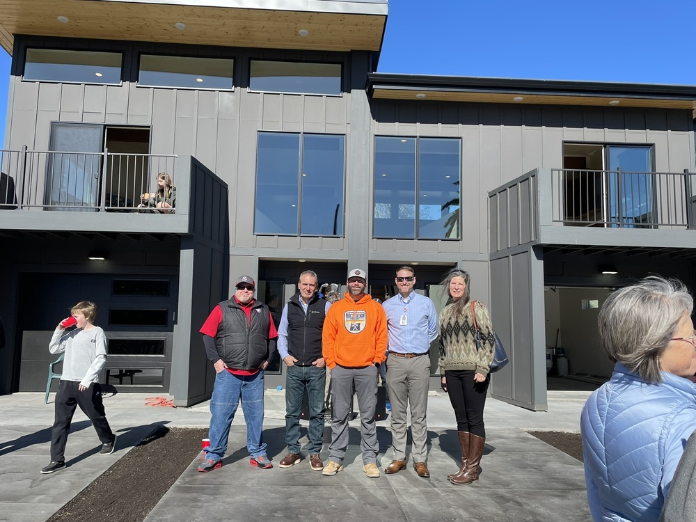 Exterior of completed tiger home with people posing during the grand opening