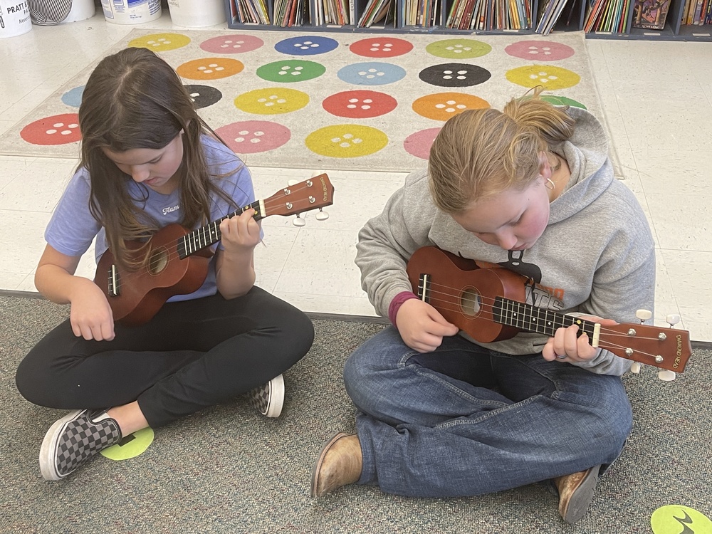 two girls playing musical instruments
