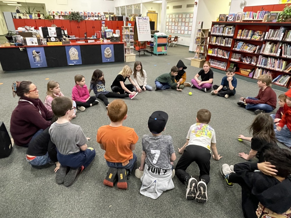 students sitting in a circle at Island City Library