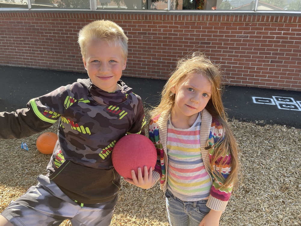 two students outside on the Greenwood playground