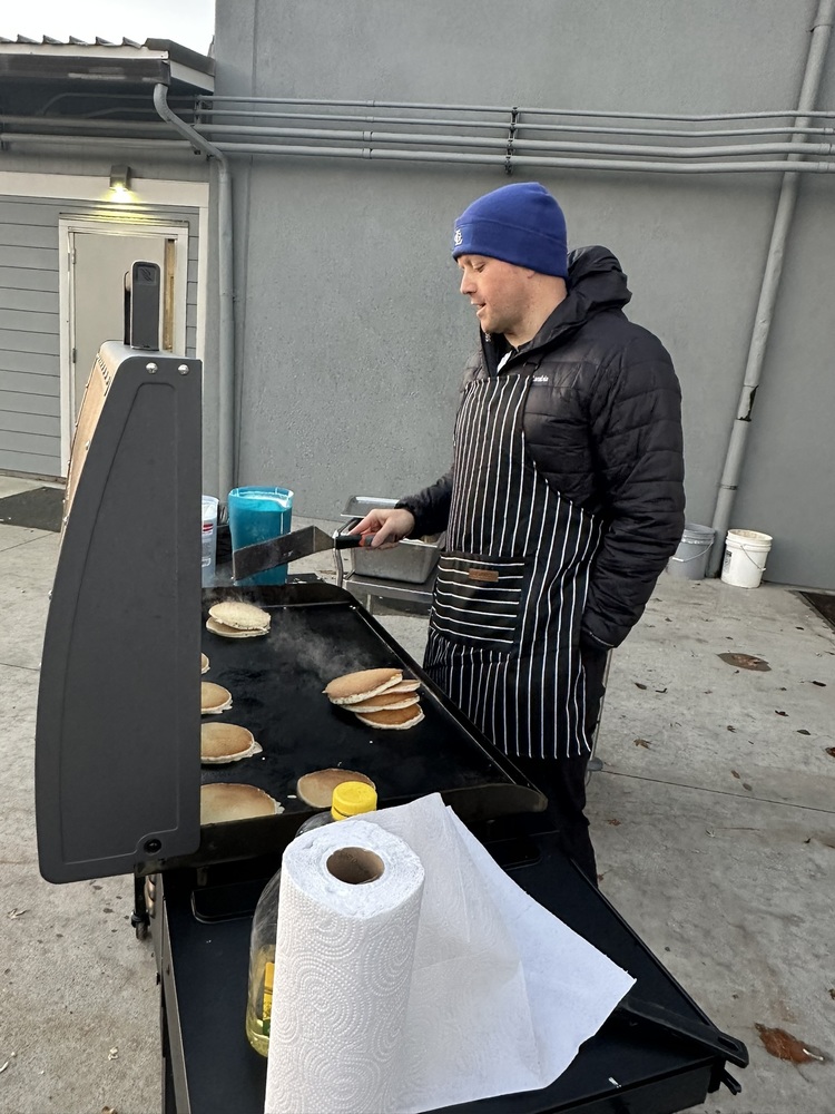Mr Smith cooking pancakes outside
