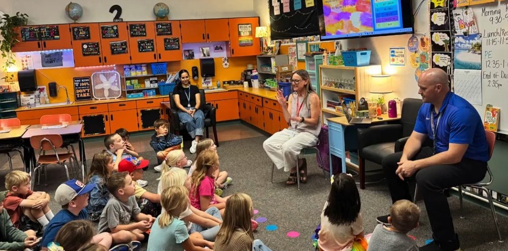photo of students in Island City Elementary in a classroom with Mr Smith and other teachers