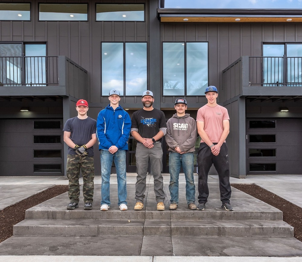 four students and instructor McKinley in front of completed Tiger Homes