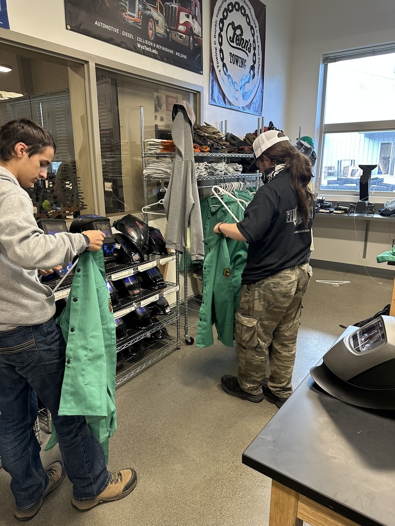 students hanging up new welding jackets
