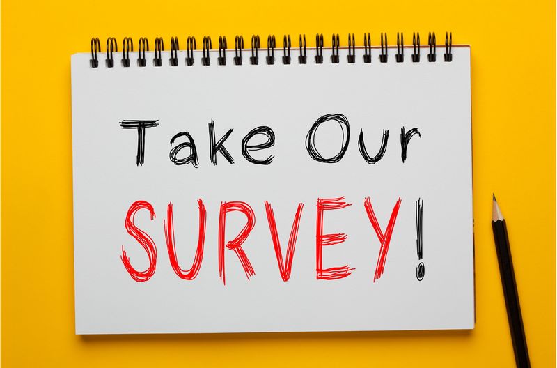 image of spiral notebook with text take our survey
