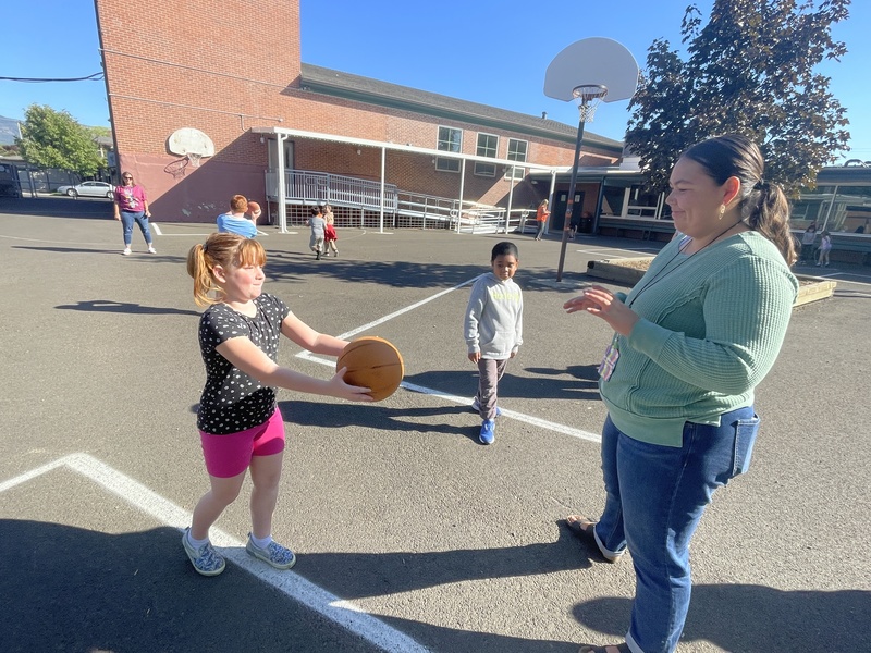 students playing basketball on the Greenwood Courtyard Playground