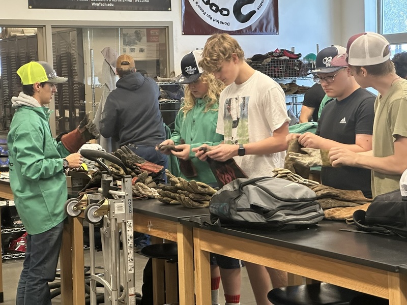 students sorting through old gear to salvage what can be used