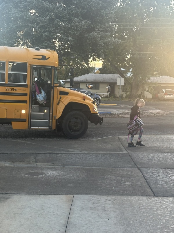 students getting off the school bus