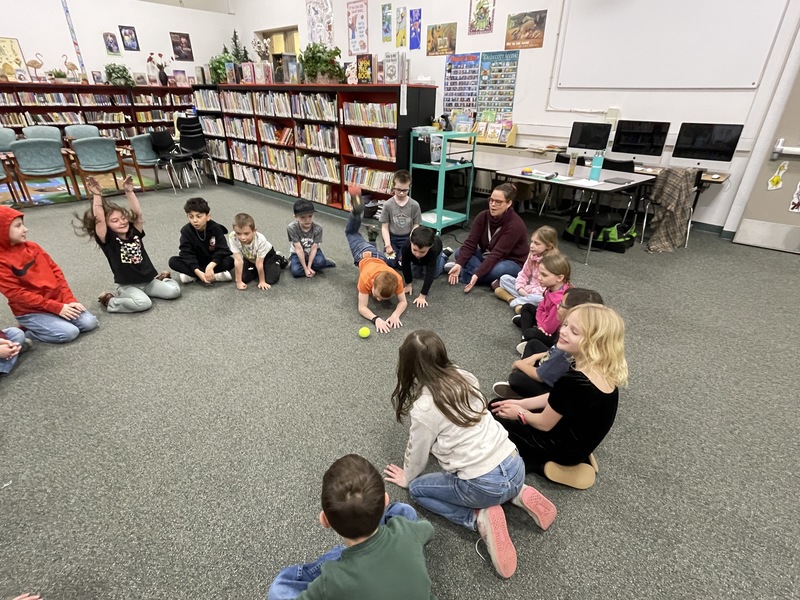 students sitting in a circle at Island City Library