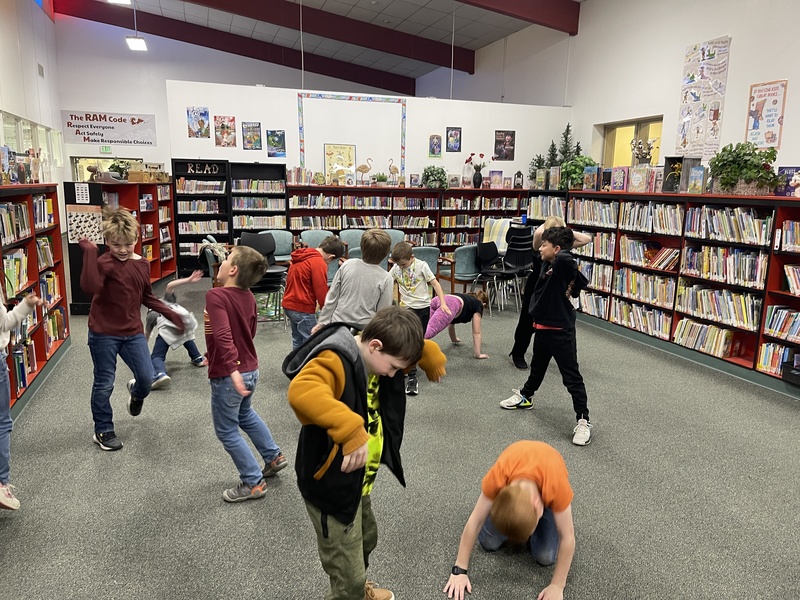 students moving around the island city elementary library