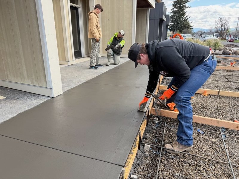 LHS students working on pouring concrete for the tiger house