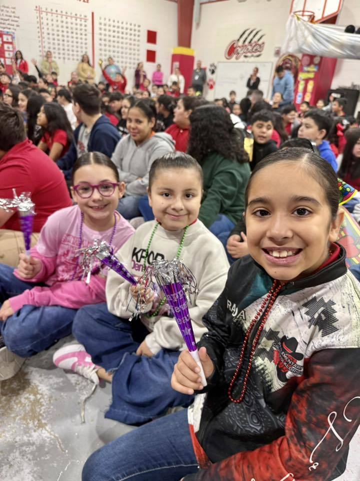 three girls holding party favors