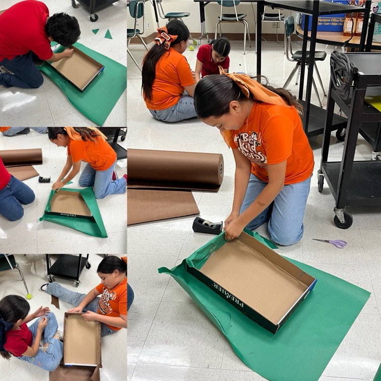 students and teachers distributing food boxes