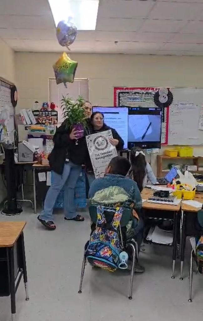 surprise visit from principal with balloons and plant