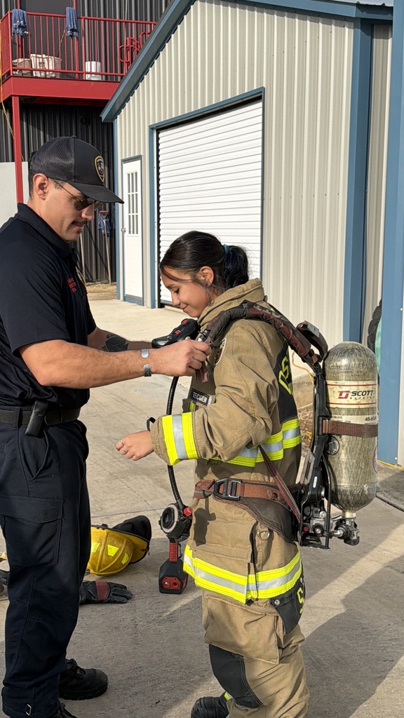 Student trying on fire fighter gear