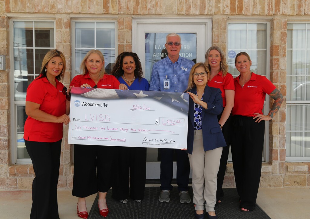 The WoodmenLife Team presents a check to La Vernia ISD for $6932.00 to help pay negative student balances. 