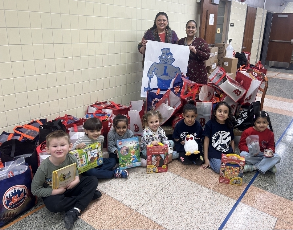 Principal of Truman Elementary School Miss Clark and Mrs. H. Nashir pose for a photo with students