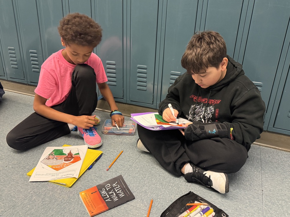 Students working on a project in the hallway