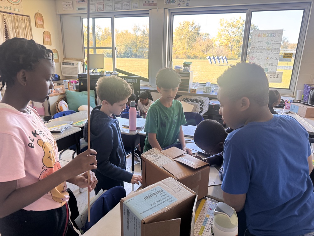 Kids work on measuring in the classroom