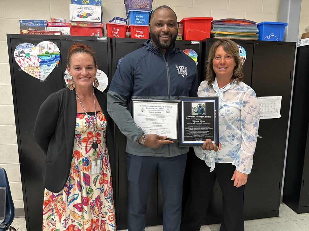 Marcus Rivers stands with Athletic Director Amy D'Amato and Principal Jen Springer. 