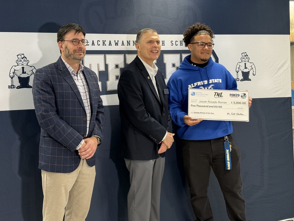 Jossiah receives his scholarship check.
