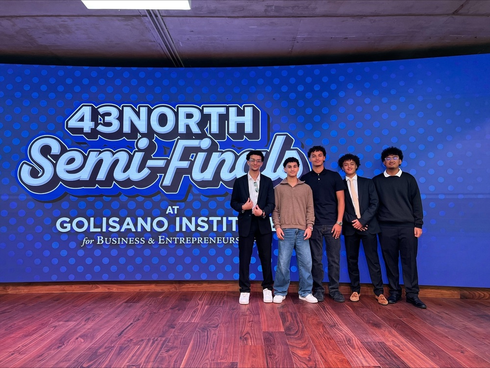 students pose in front of 43 north sign