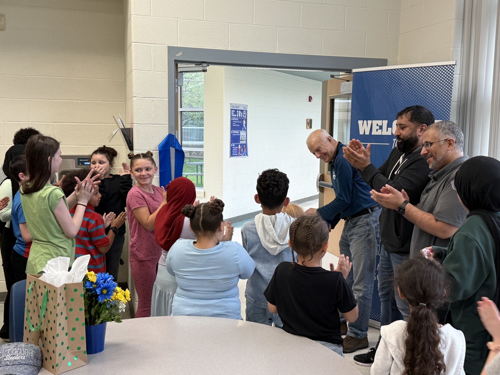 Mr. Sanders cuts the ribbon  to open the playground.