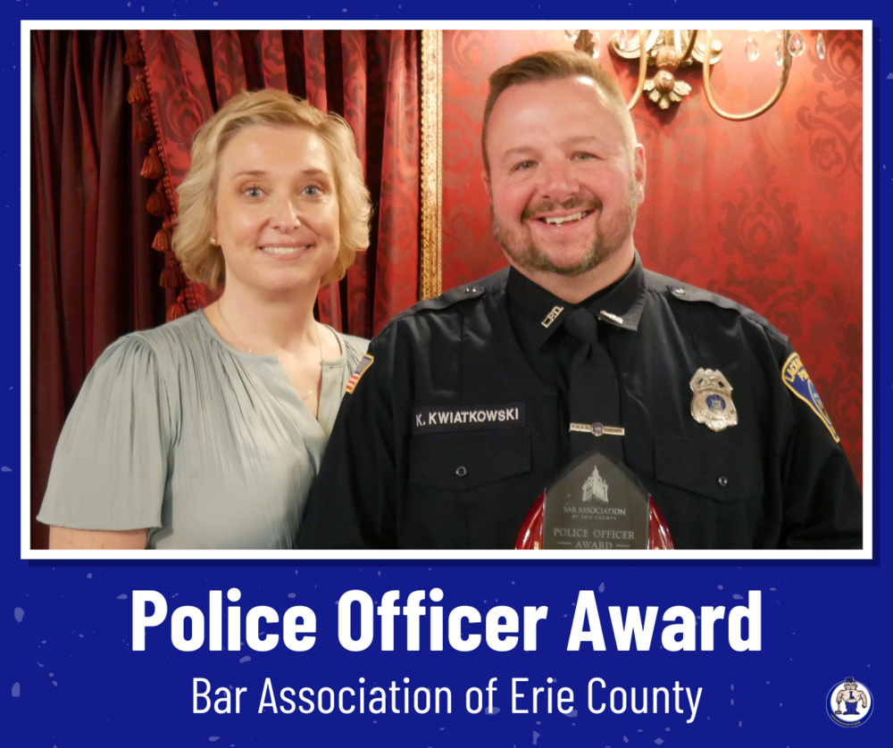 Officer Kwiatkowski and wife, heather, pose with his police officer award