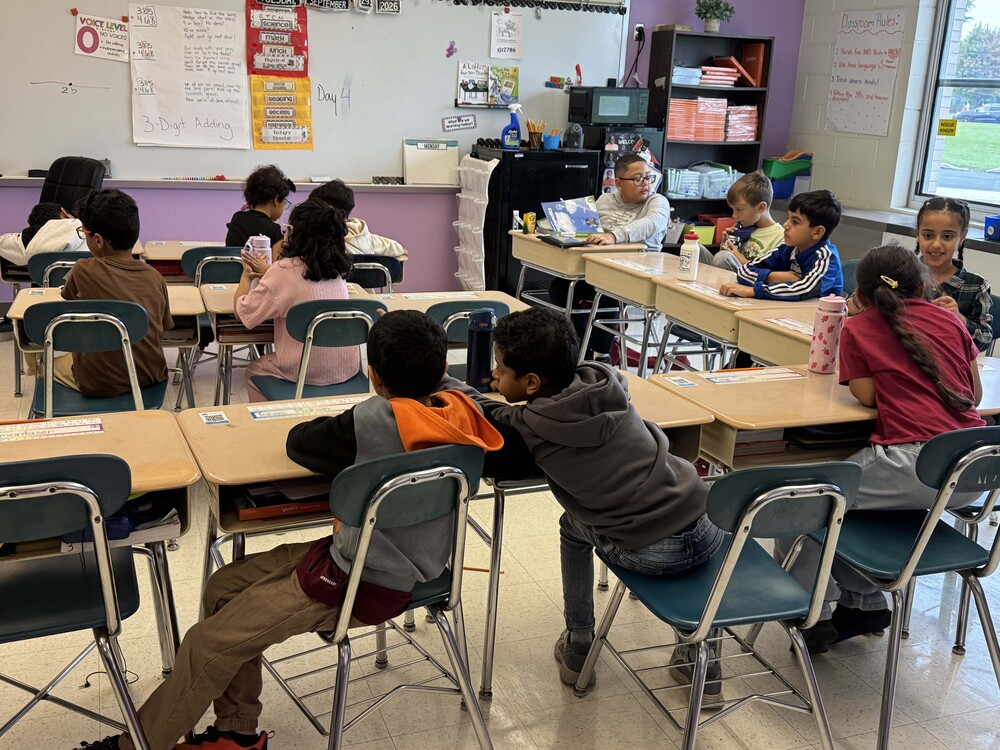 students work at desks in classroom