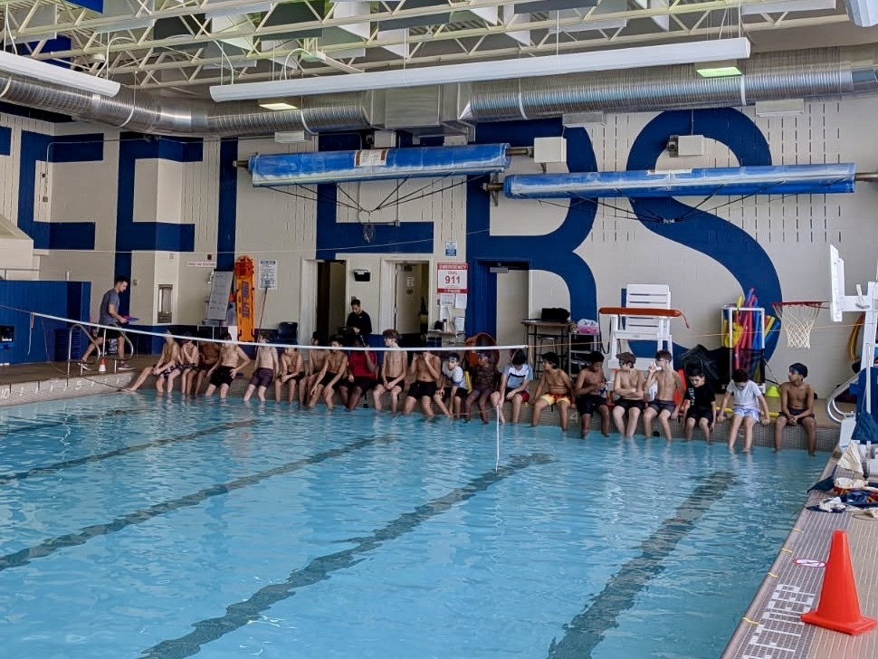 LMS boys sit by the pool.