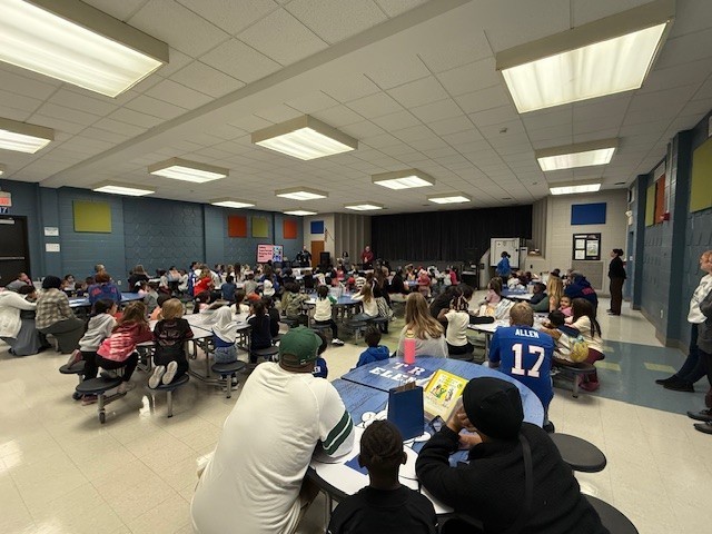 Families gather in cafeteria.