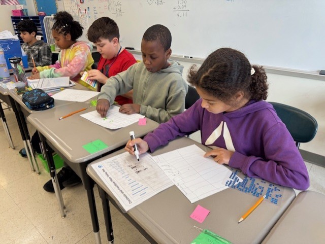 Students work on math in class.