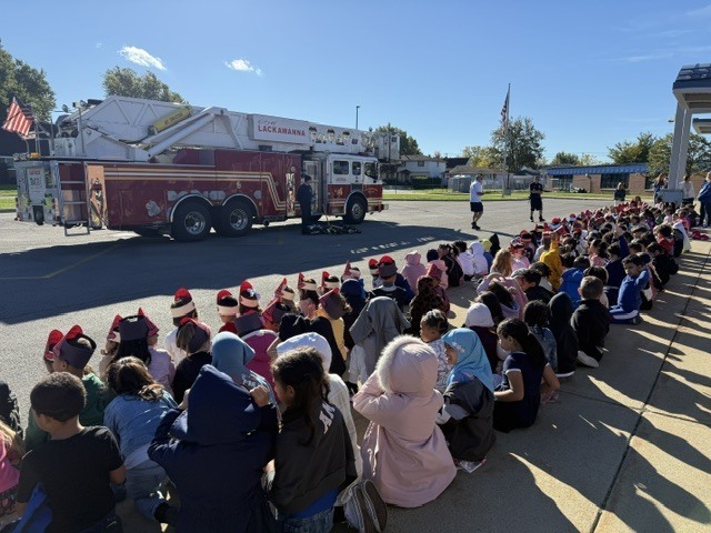 students watching fire truck demonstration