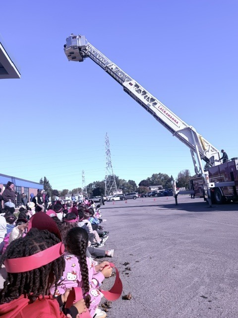 students watching fire truck demonstration