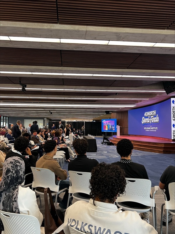 students watching presentation in front of big screen